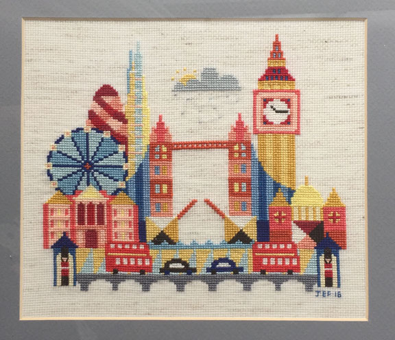 A modern cross stitch depicting iconic buildings from London, England including the London Eye, the London Bridge, the Shard, the Gherkin, Big Ben, St. Paul's Cathedral, Buckingham Palace, london taxis, and red double decker buses.